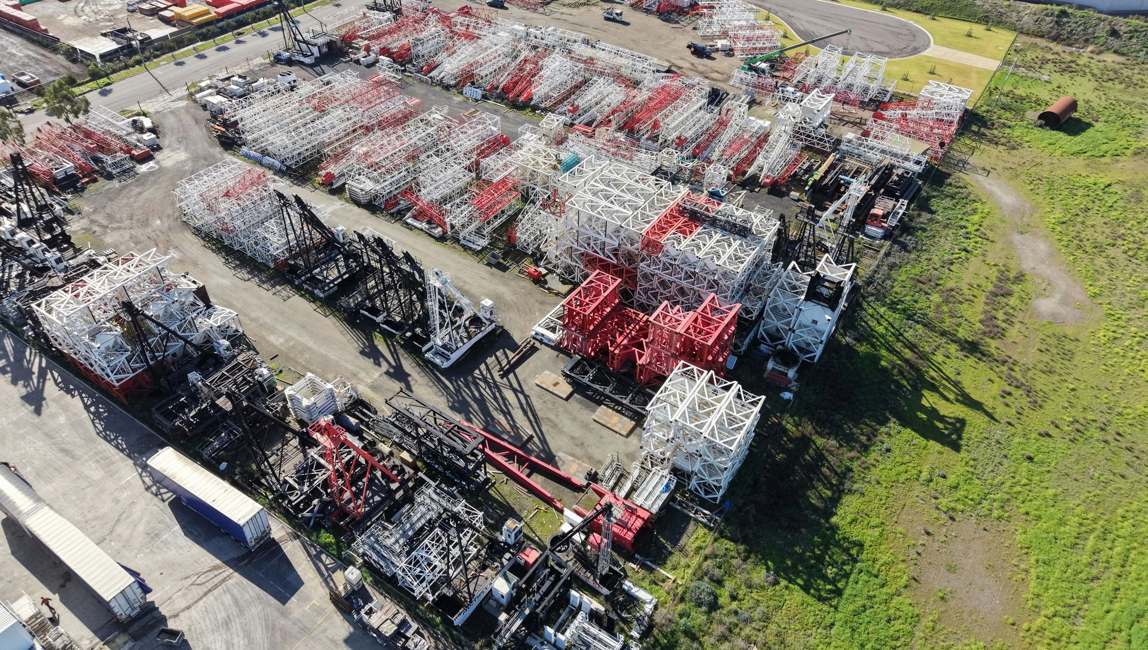 Industrial parts storage yard with organized heavy equipment components